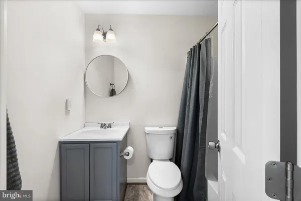 a bathroom with a toilet a sink and mirror