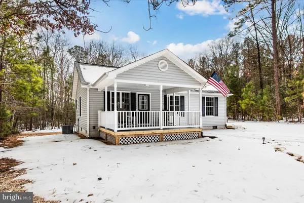 a view of a house with a wooden fence