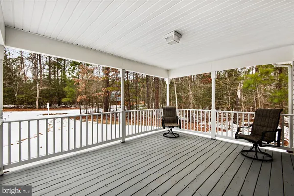a view of a balcony with wooden floor