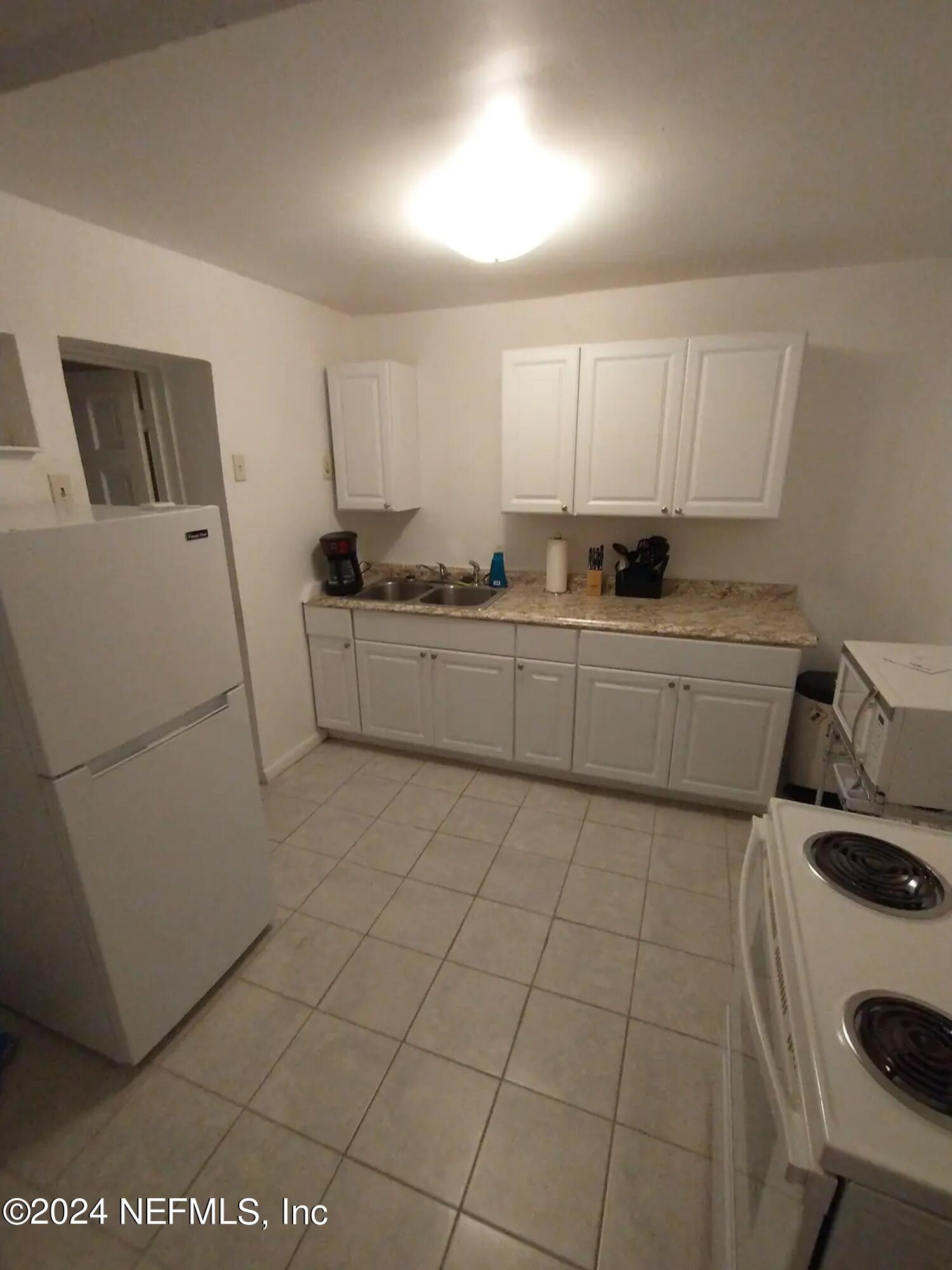 5419 Woodcrest Road Jacksonville, FL 32205 - Photo 13 of 25 a kitchen with a sink and cabinets