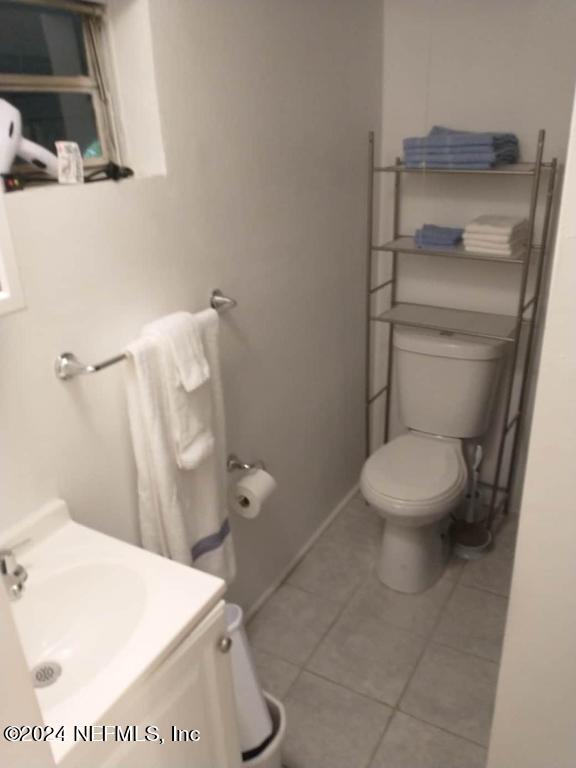 5419 Woodcrest Road Jacksonville, FL 32205 - Photo 20 of 25 a white toilet sitting next to a white sink and vanity