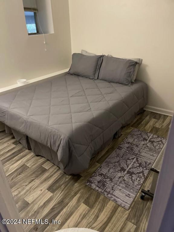 5419 Woodcrest Road Jacksonville, FL 32205 - Photo 25 of 25 a bed sitting in a bedroom next to a wall