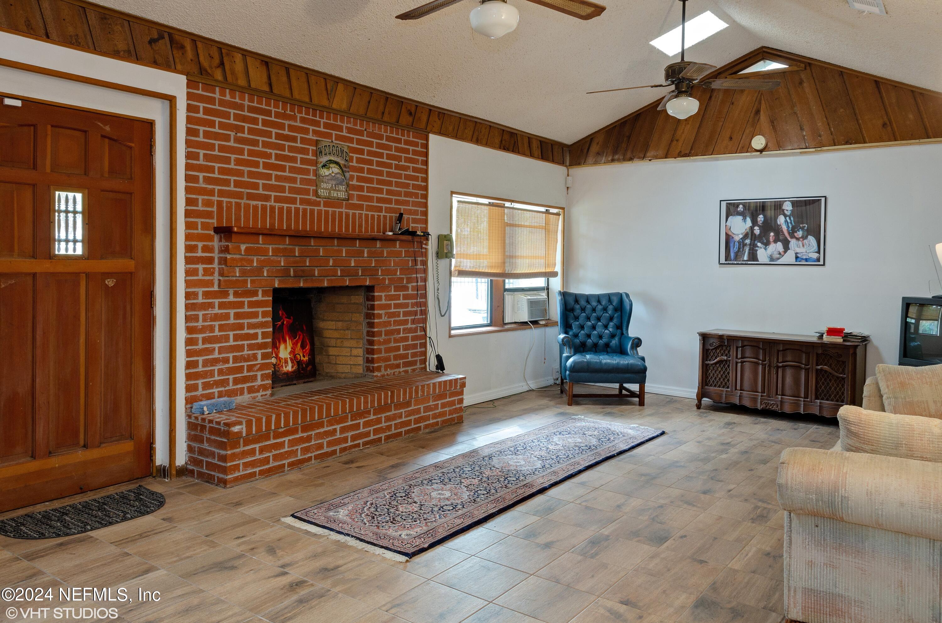 5419 Woodcrest Road Jacksonville, FL 32205 - Photo 3 of 25 a living room with furniture and a fireplace