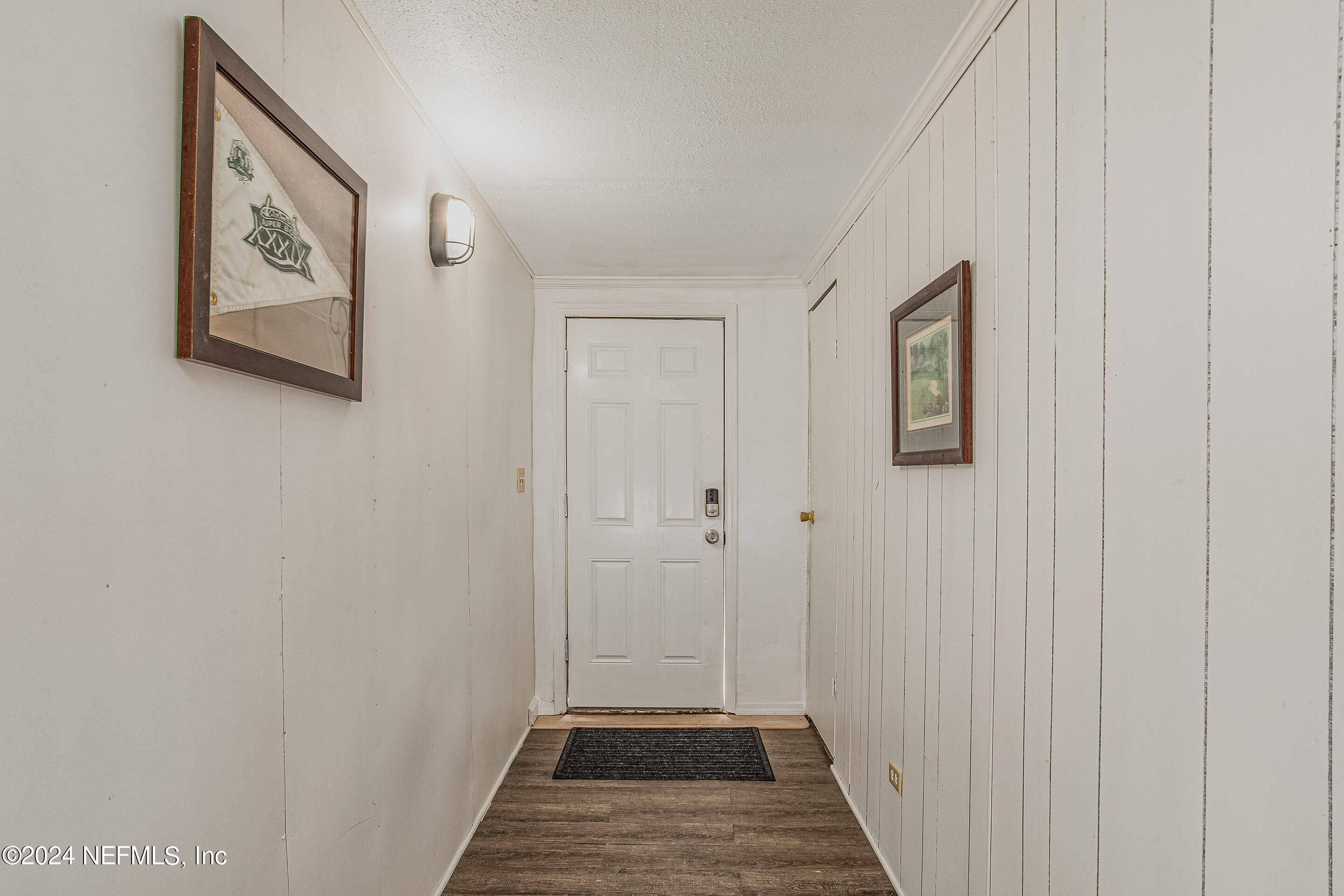 5419 Woodcrest Road Jacksonville, FL 32205 - Photo 6 of 25 a view of a hallway with wooden floor and closet