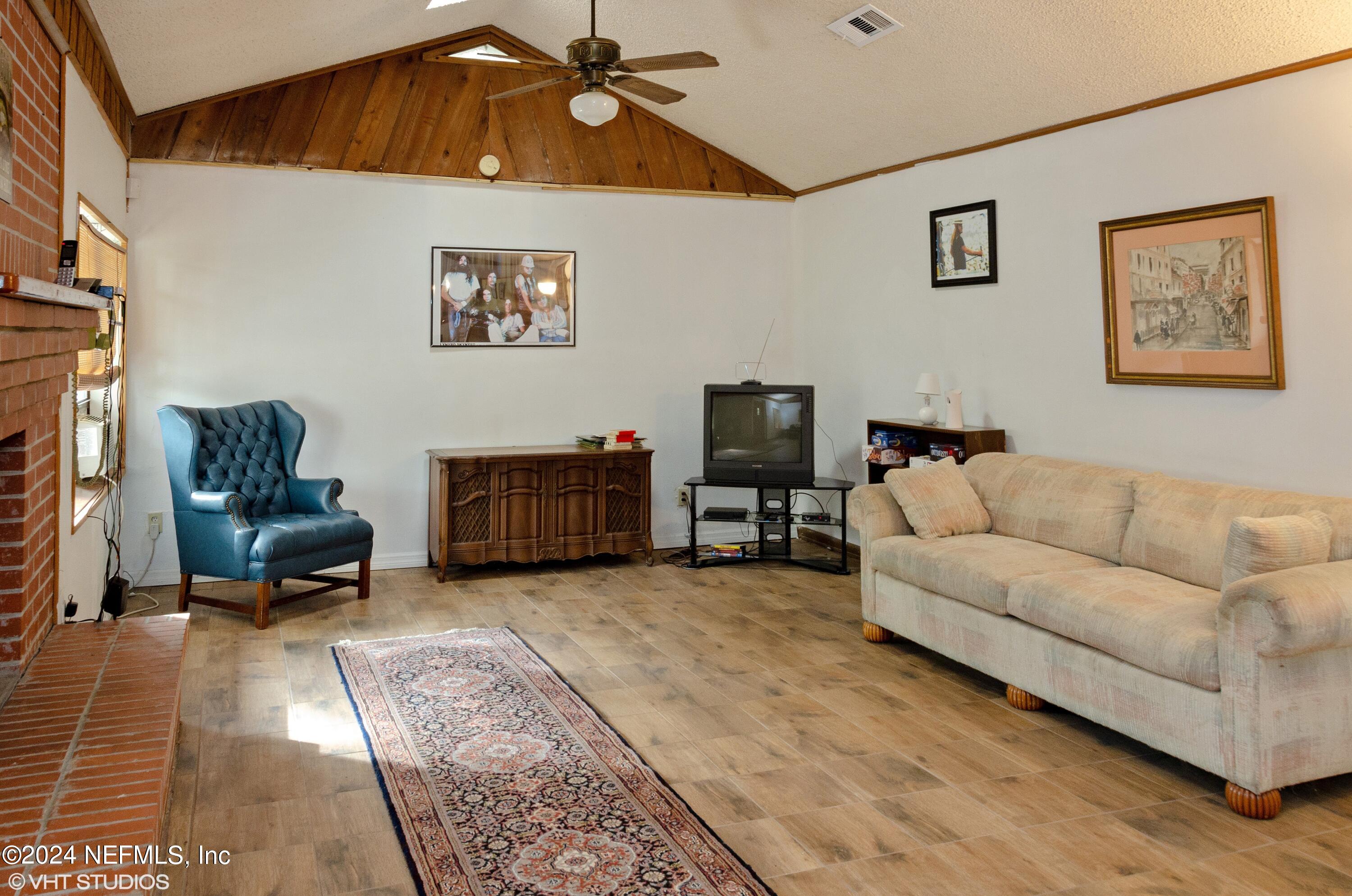 5419 Woodcrest Road Jacksonville, FL 32205 - Photo 7 of 25 a living room with furniture and a flat screen tv