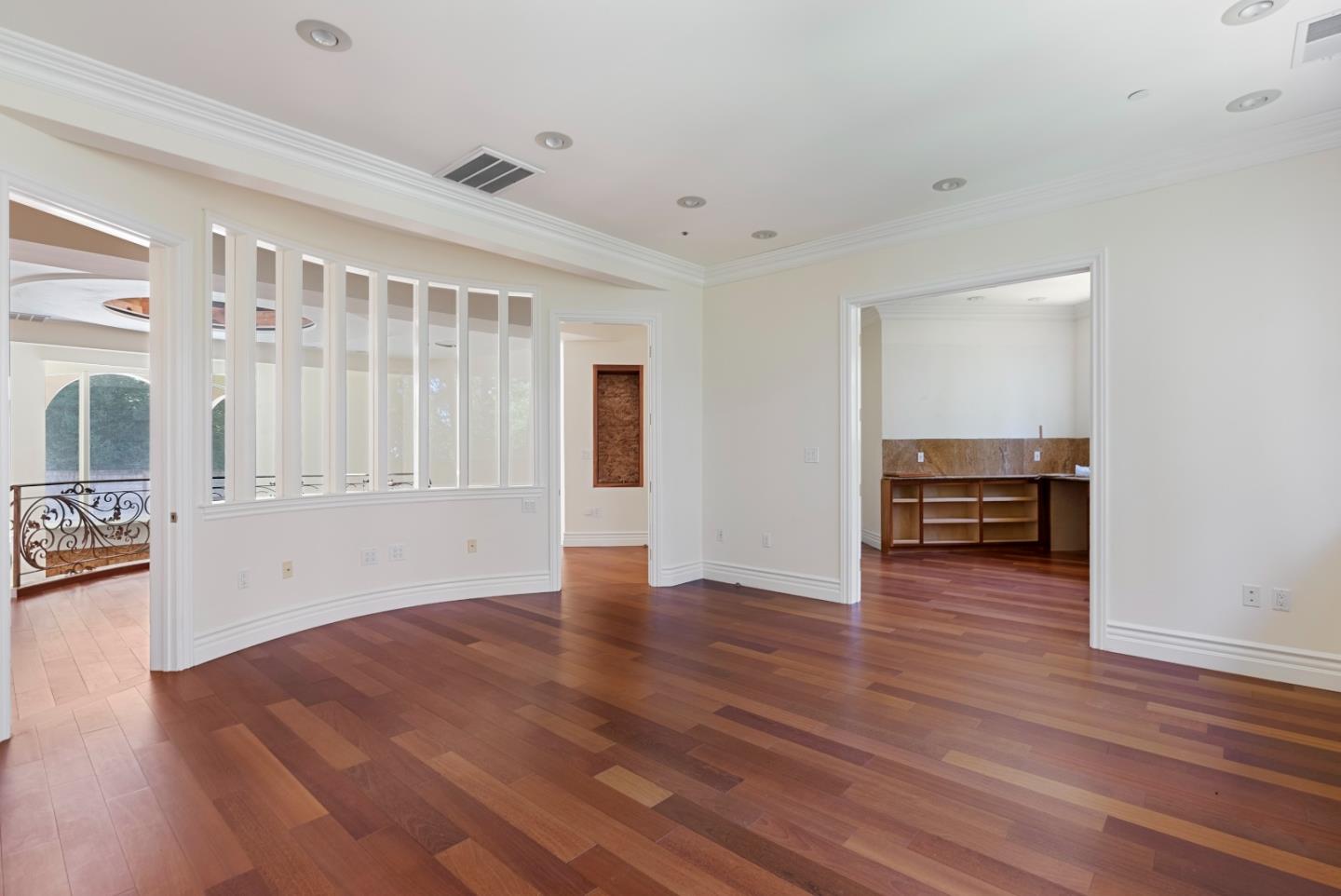 1 Reids Roost Road Woodside, CA 94062 - Photo 11 of 24 a view of empty room with wooden floor and fireplace