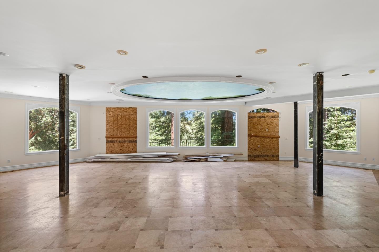 1 Reids Roost Road Woodside, CA 94062 - Photo 6 of 24 a view of an empty room with floor to ceiling window and wooden floor