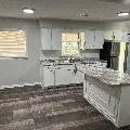 a view of a kitchen with granite countertop cabinets