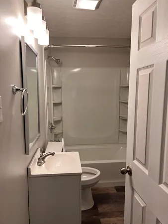 a bathroom with a sink toilet and shower