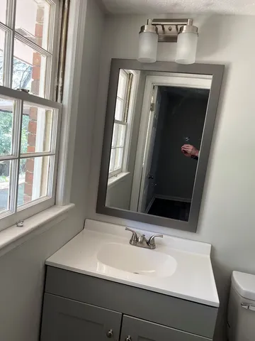a bathroom with a sink and a mirror