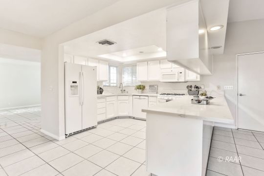 528 South Sorrel Street Ridgecrest, CA 93555 - Photo 4 of 27 a kitchen with white cabinets and white appliances