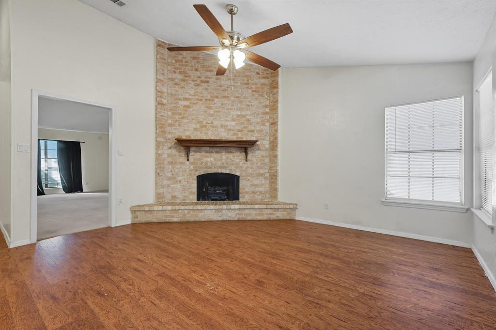 9101 Denver Street Rowlett, TX 75088 - Photo 18 of 40 an empty room with windows and fireplace