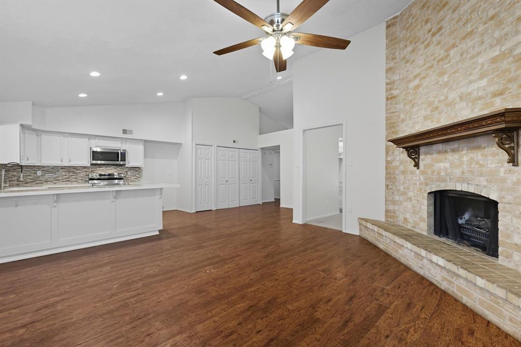 9101 Denver Street Rowlett, TX 75088 - Photo 19 of 40 a kitchen with a refrigerator and white cabinets