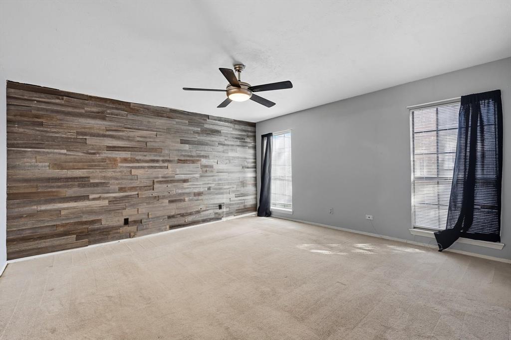 9101 Denver Street Rowlett, TX 75088 - Photo 21 of 40 a view of an empty room with a ceiling fan and window