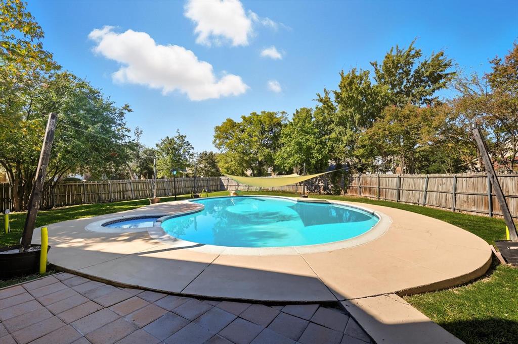 9101 Denver Street Rowlett, TX 75088 - Photo 31 of 40 a view of a swimming pool with a yard and sitting area
