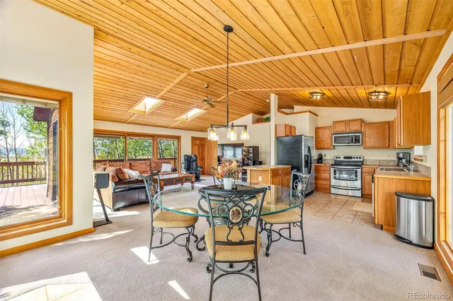 a dining room with furniture and a view of kitchen