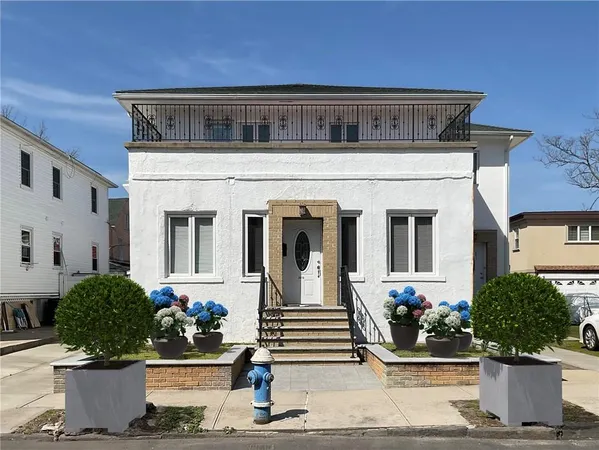 a front view of a house with lots of potted plants