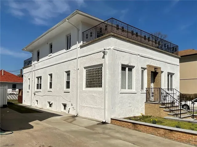 a front view of a house with large windows