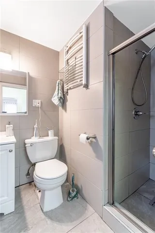 a bathroom with a toilet and a shower