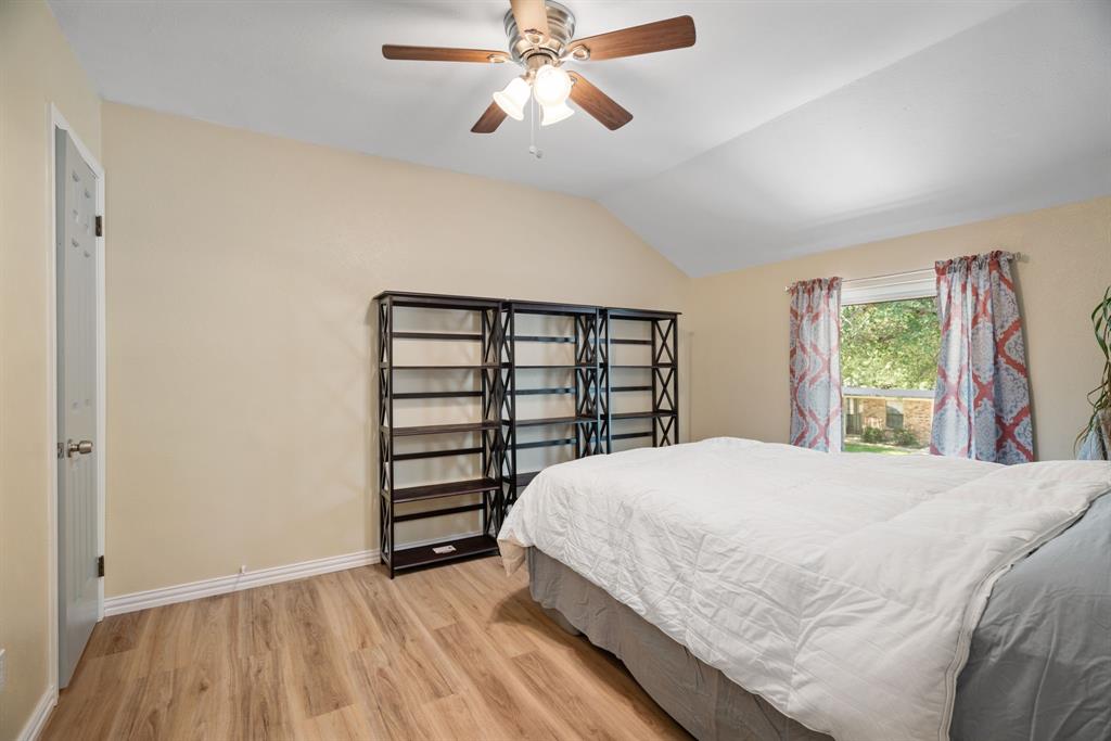 2960 Harbinger Lane Dallas, TX 75287 - Photo 14 of 25 a bedroom with a bed and a chandelier