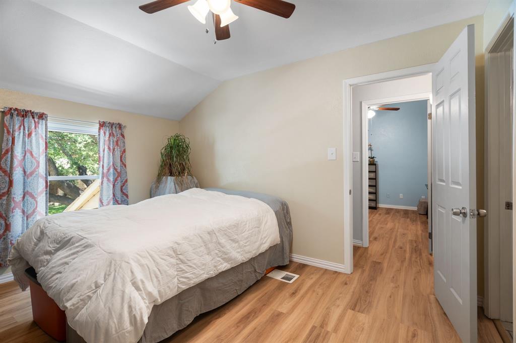 2960 Harbinger Lane Dallas, TX 75287 - Photo 15 of 25 a bed room with a bed and a chandelier