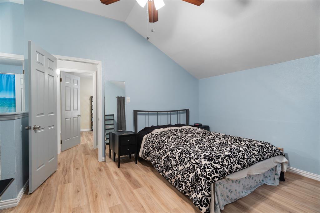 2960 Harbinger Lane Dallas, TX 75287 - Photo 17 of 25 a bedroom with a bed and a chandelier