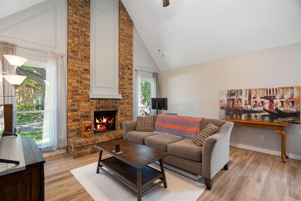 2960 Harbinger Lane Dallas, TX 75287 - Photo 8 of 25 a living room with furniture and a fireplace