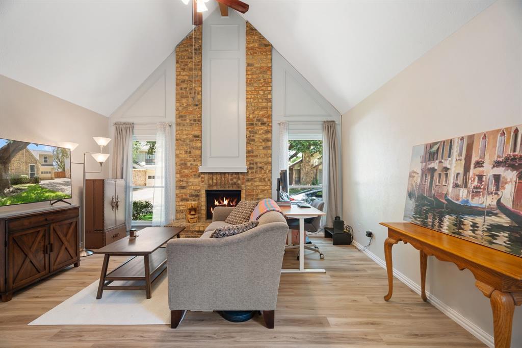 2960 Harbinger Lane Dallas, TX 75287 - Photo 9 of 25 a living room with furniture and a fireplace