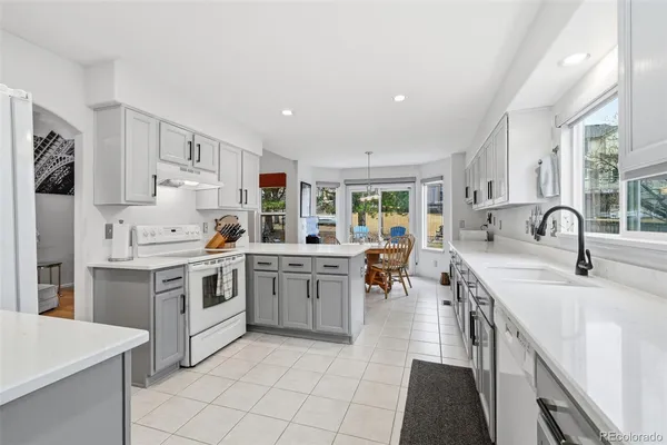 a kitchen with a sink stove and cabinets