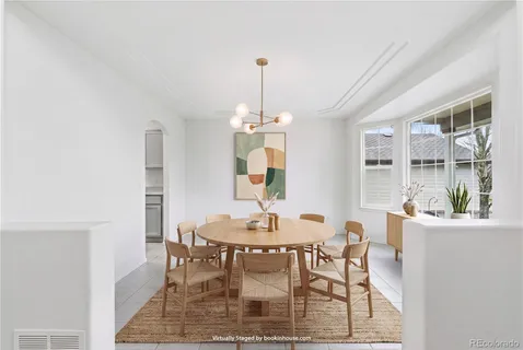 a dining room with furniture window and wooden floor
