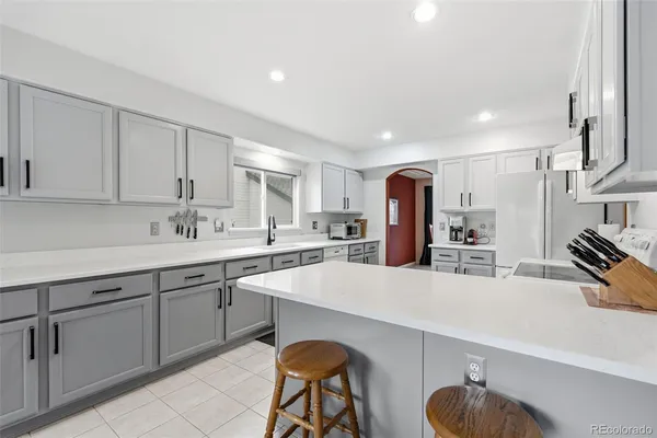 a large kitchen with kitchen island a sink stainless steel appliances and cabinets