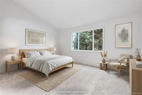 a bedroom with a bed and a large window