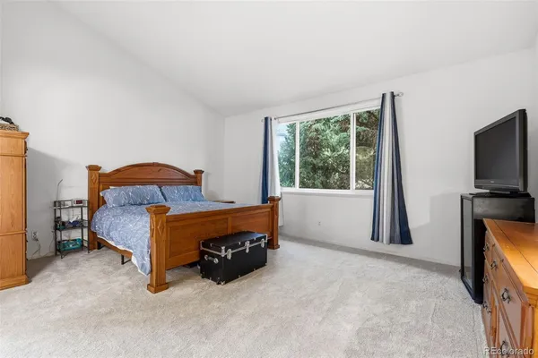 a bed sitting in a bedroom next to a window