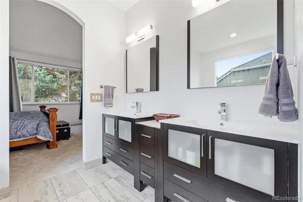 a bathroom with a double vanity sink a mirror and a bathtub