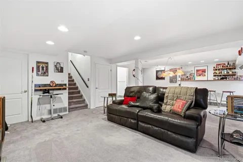 a living room with furniture and stairs