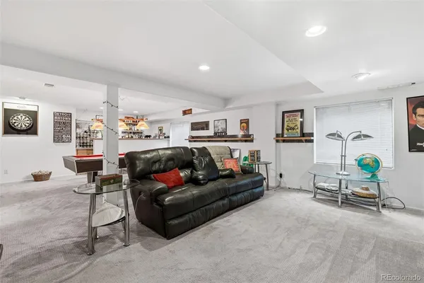 a living room with furniture and a lamp
