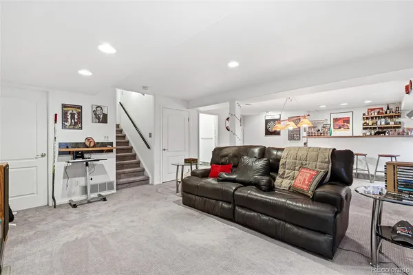 a living room with furniture and stairs