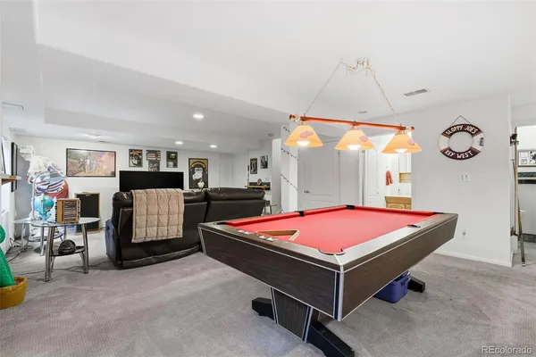 a room with table tennis air hockey table and arcade game machine
