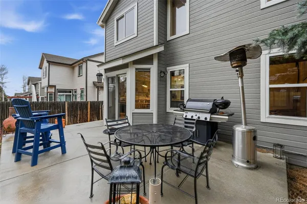 a view of a patio with a table and chairs