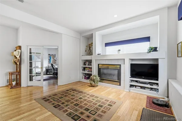 a living room with a flat screen tv and a fireplace