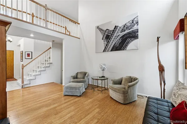 a living room with furniture and stairs
