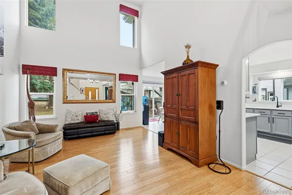a living room with furniture window and wooden floor