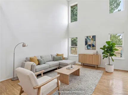 a living room with furniture potted plant and a lamp