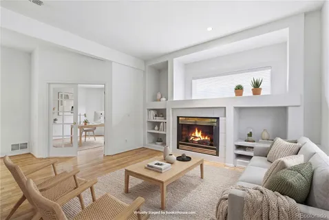 a living room with furniture and a fireplace