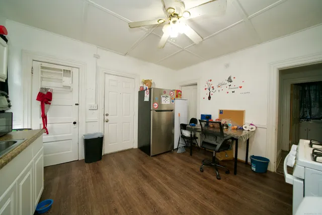 a kitchen with sink a stove and white cabinets