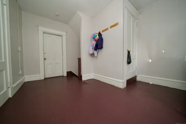 an empty room with windows and closet