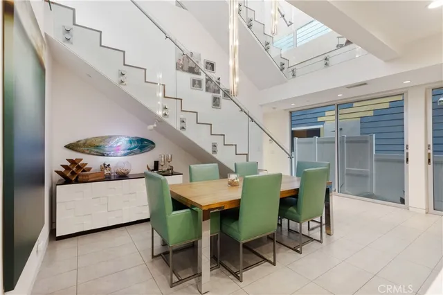 a view of a dining room with furniture and a chandelier
