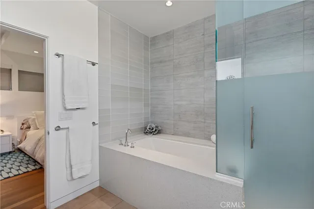 a bathroom with a double vanity sink mirror and bathtub
