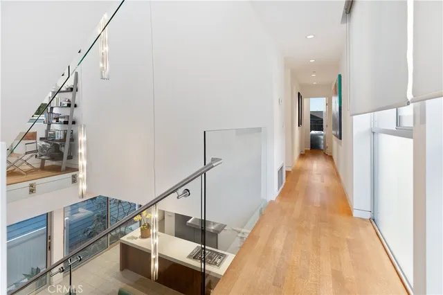 a bedroom with a bed a chair and a potted plant