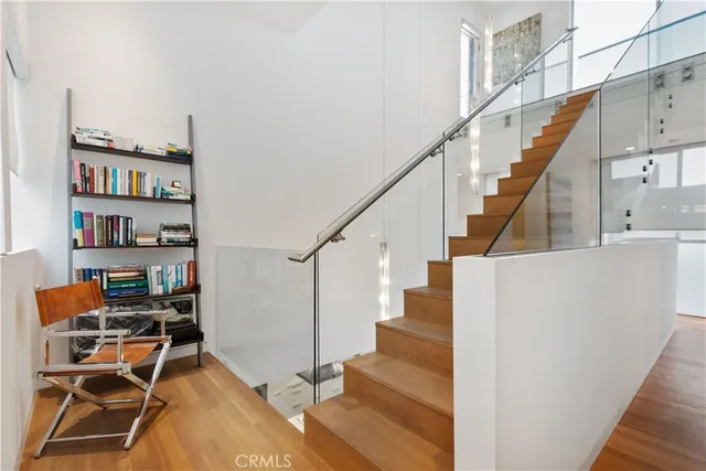 a view of entryway and hall with wooden floor